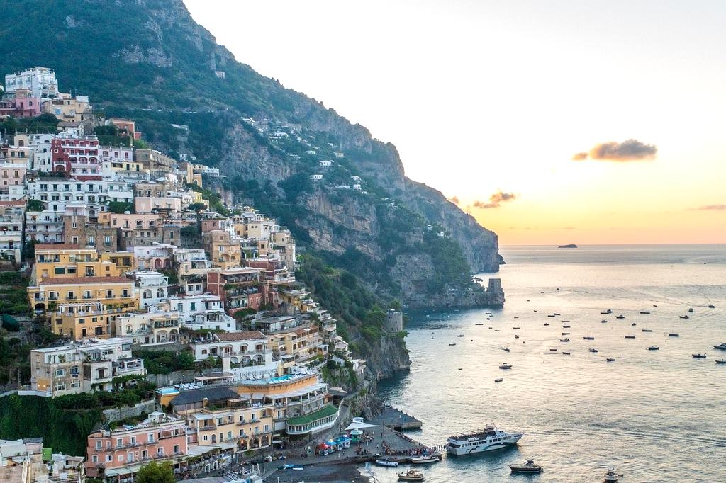 Coastal town skyline with colorful buildings and sunset reflections