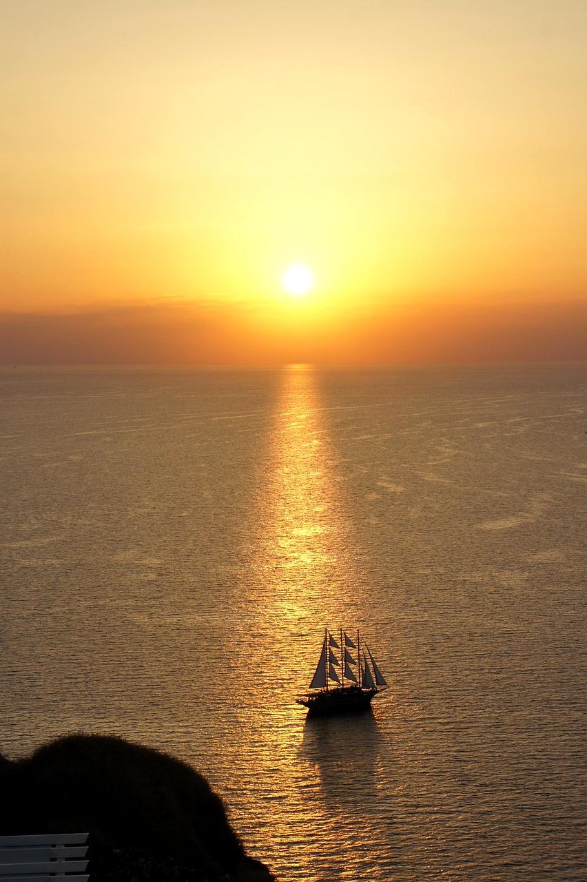Golden sun setting over Santorini domes with the Aegean Sea